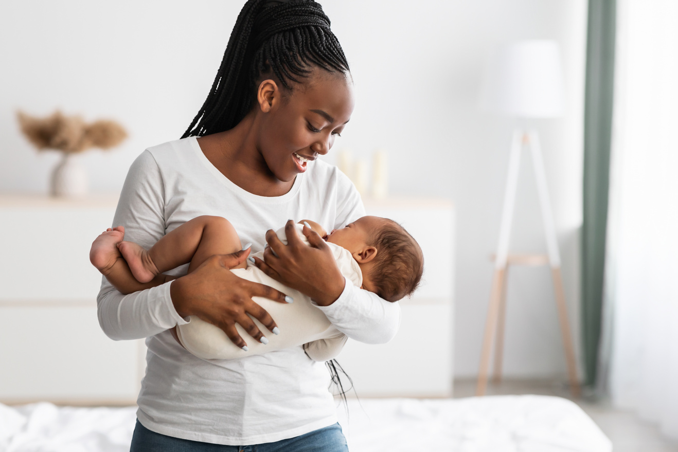 African American mother singing lullaby for infant to sleep